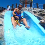 Kari and Tory sliding down a kiddie slide