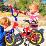 Tegan seizes a moment to steal a turn on the bike. Not quite big enough yet.