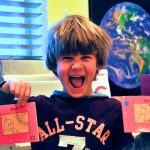 Forced smile aside, I think he's pretty happy about these books.