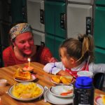 Tegan prepares to blow out her cupcake candle