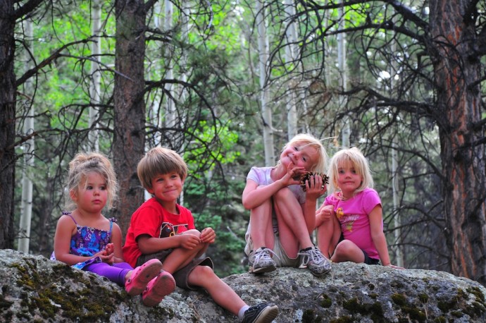 The kids find a big rock to call their castle.